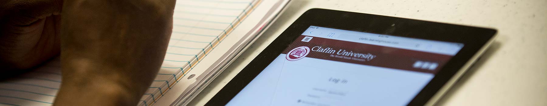 Student on Claflin website on tablet